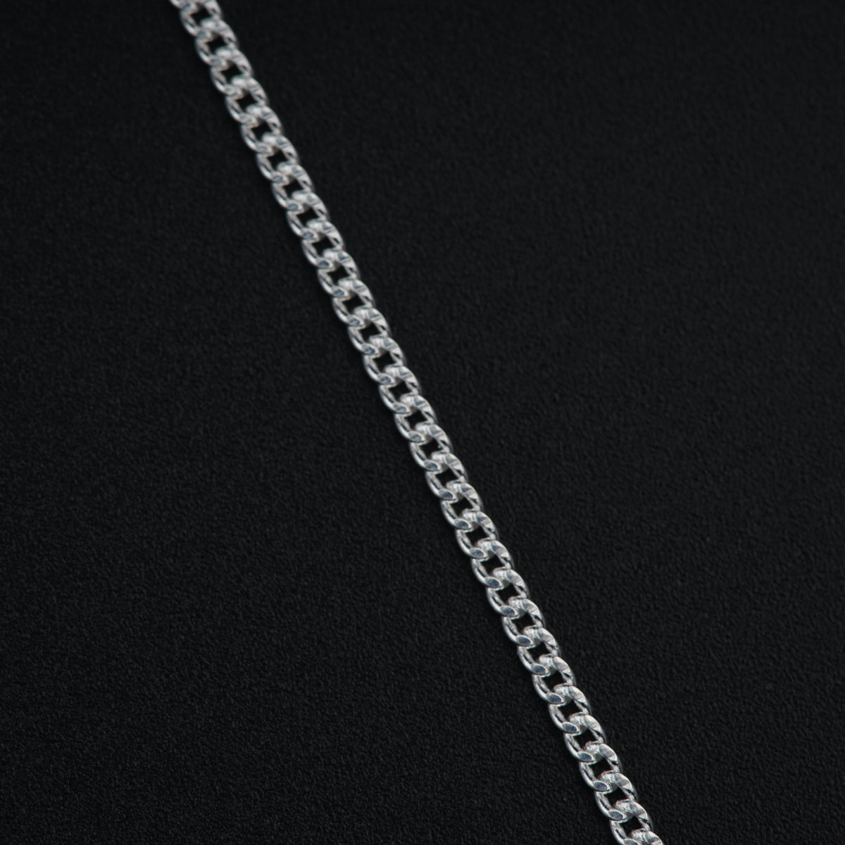 a silver chain on a black background