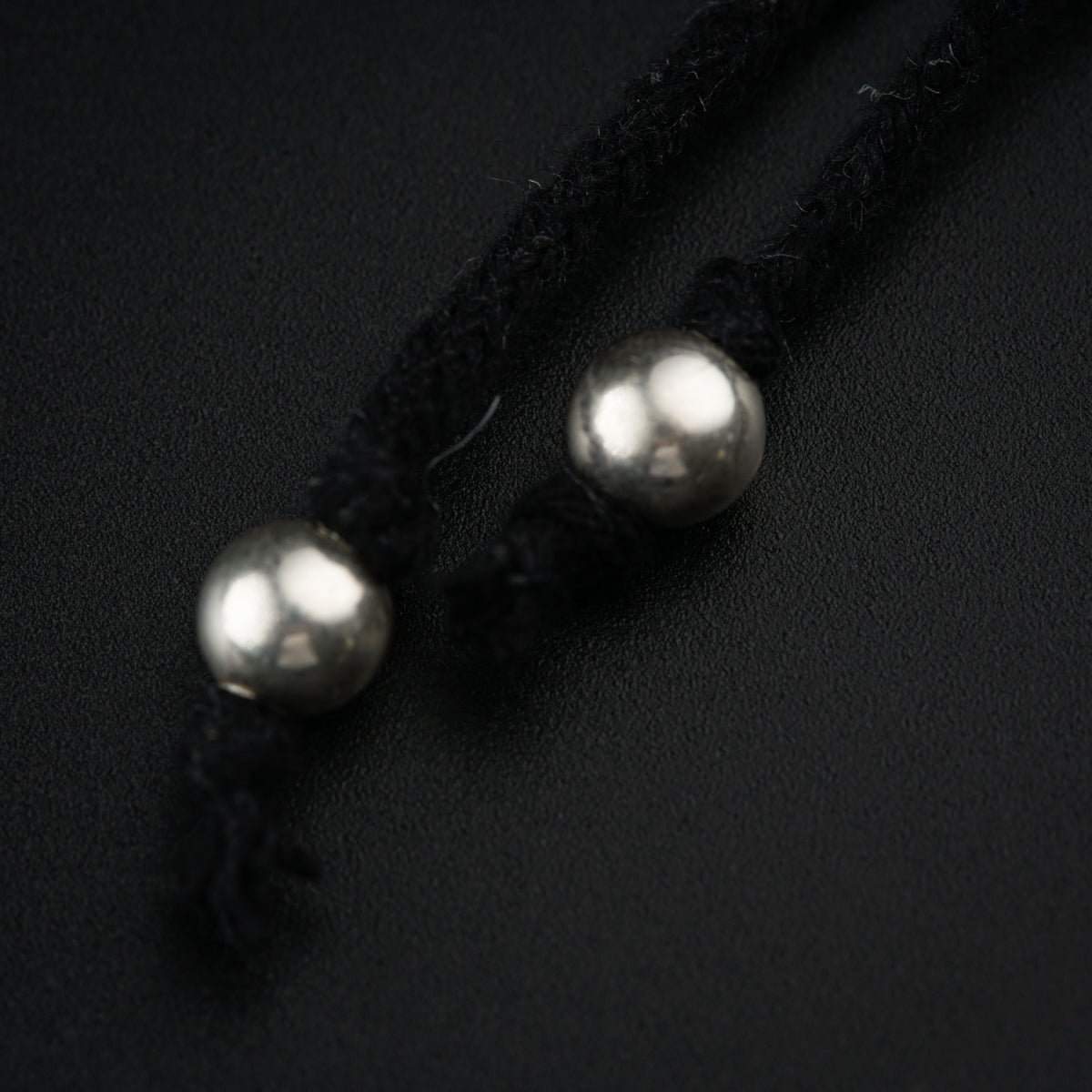 a close up of two pearls on a string