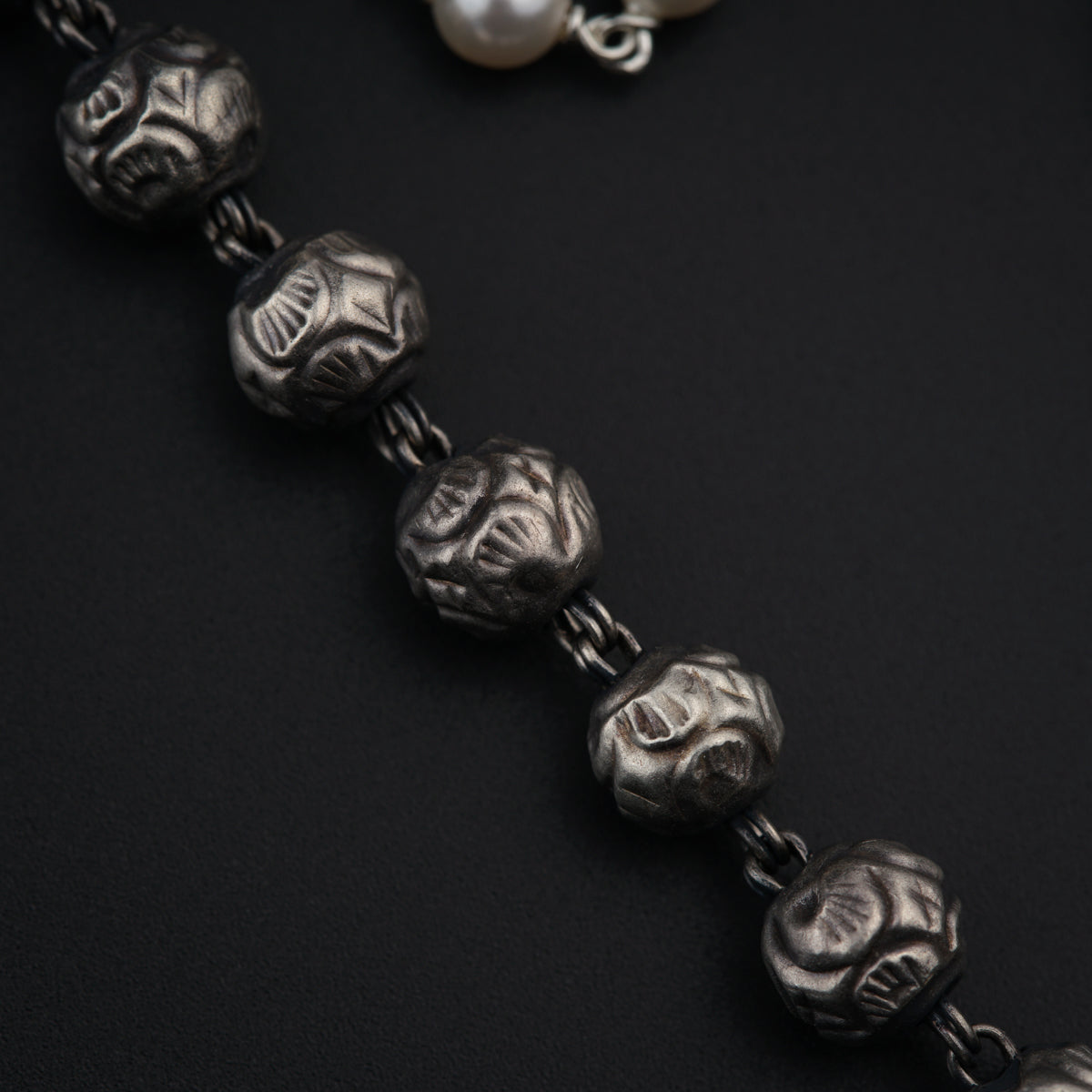 a close up of a necklace with beads