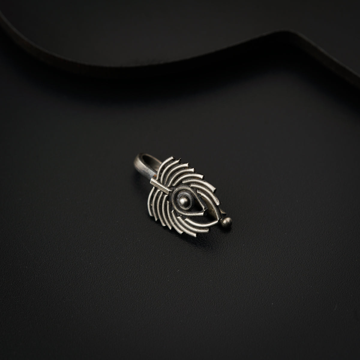 a close up of a ring on a black surface