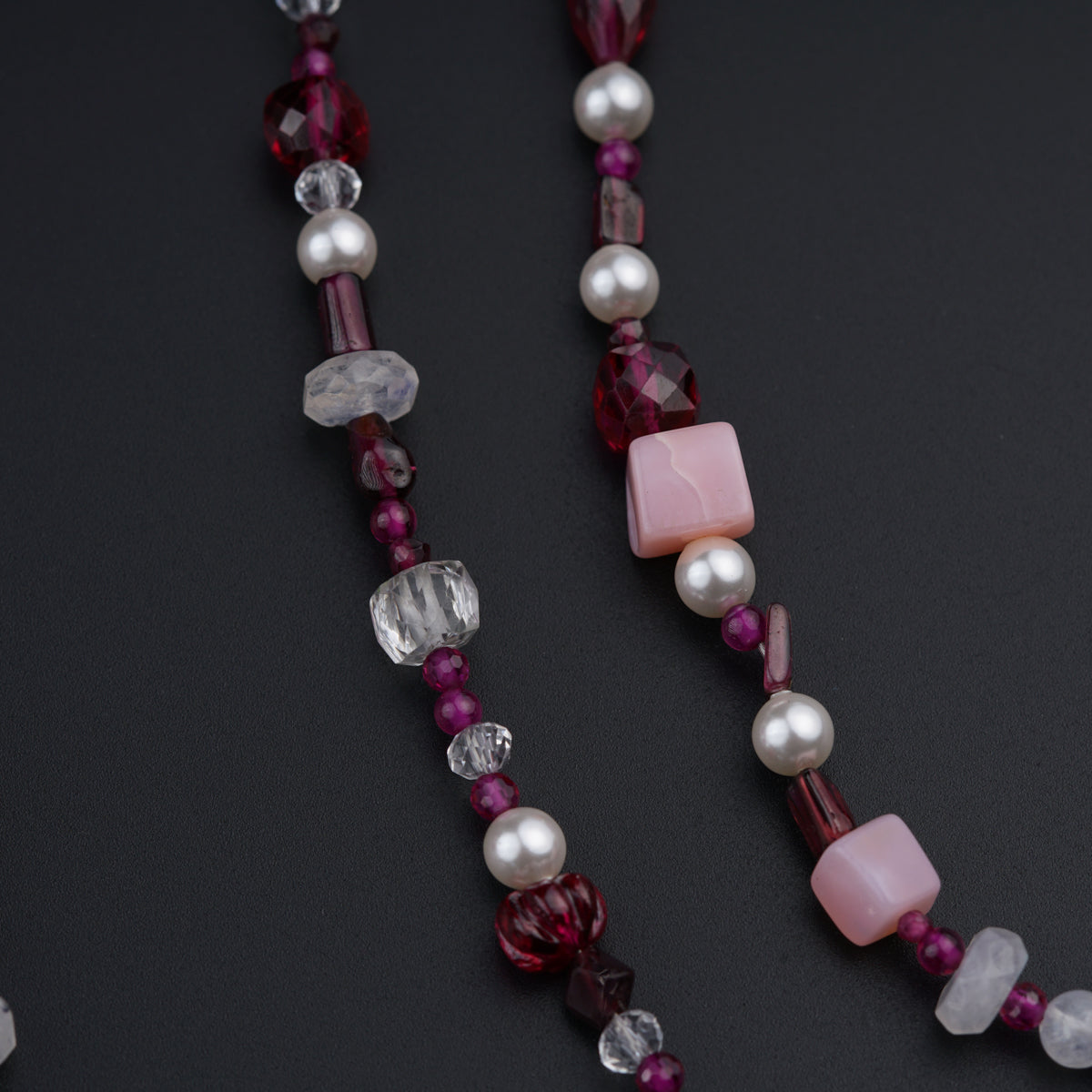a close up of a necklace on a black surface
