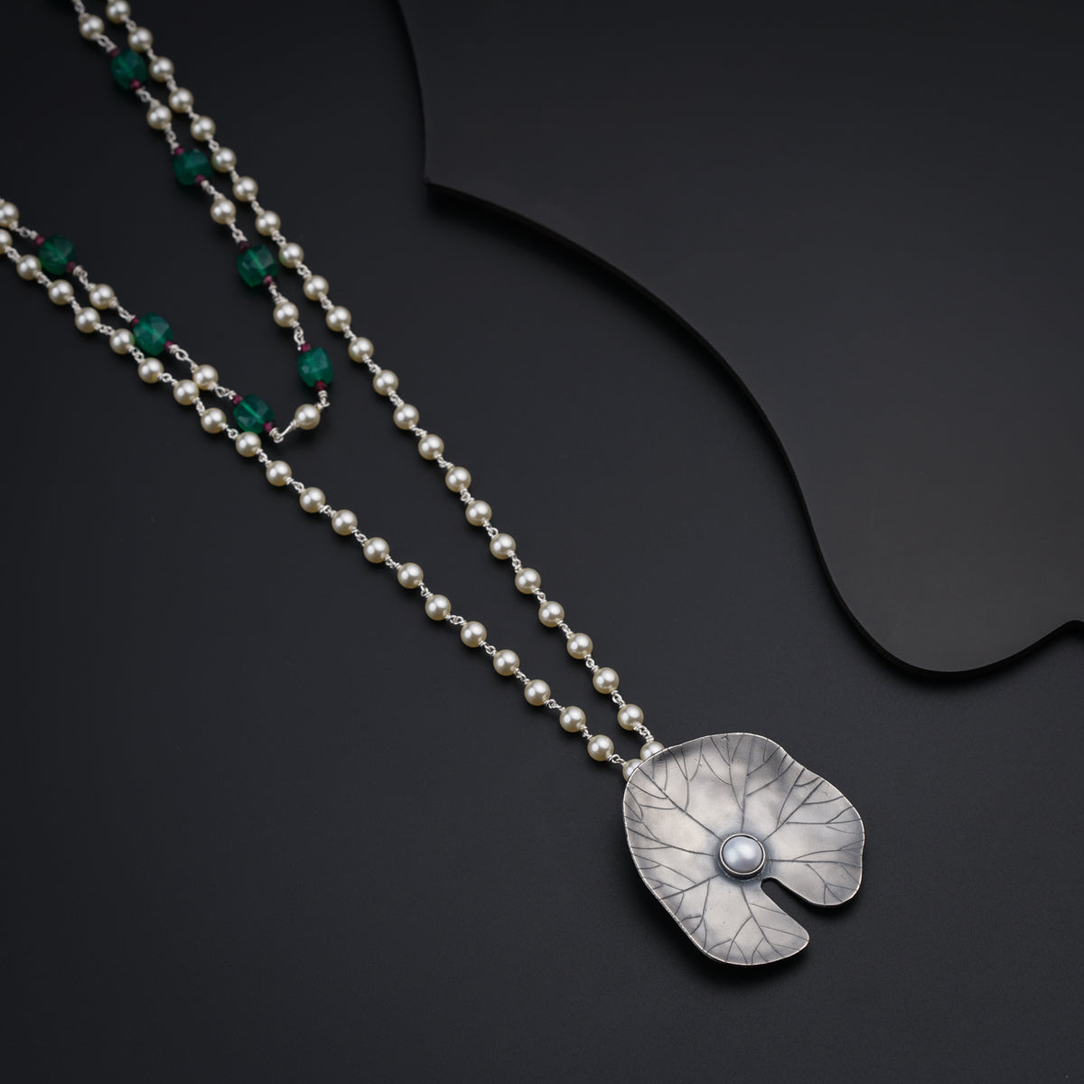 a necklace with a flower on a chain