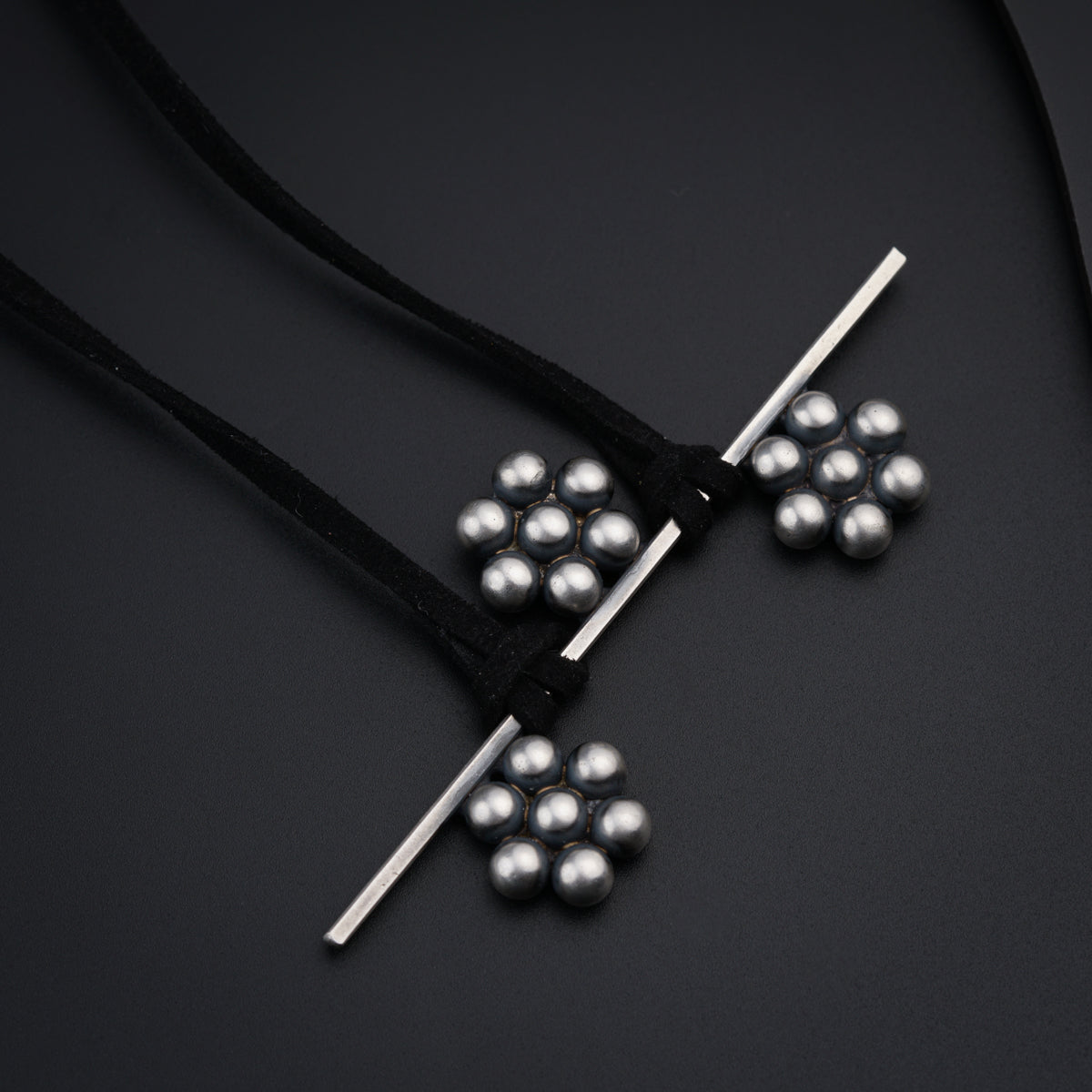 a bunch of silver balls sitting on top of a black surface