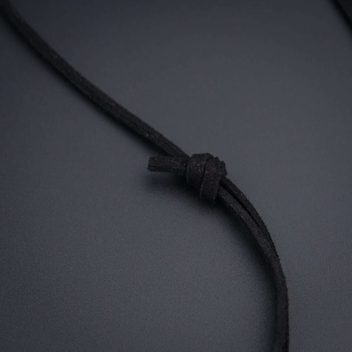 a close up of a black cord on a gray surface