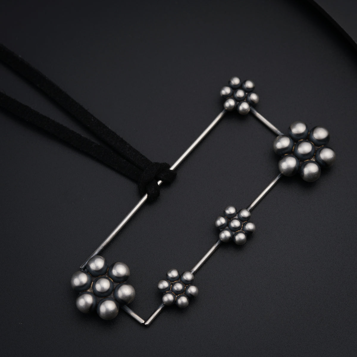 a close up of a metal object on a black surface