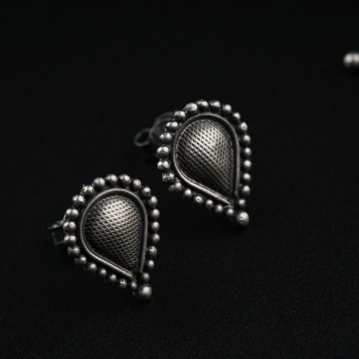 a pair of earrings sitting on top of a table