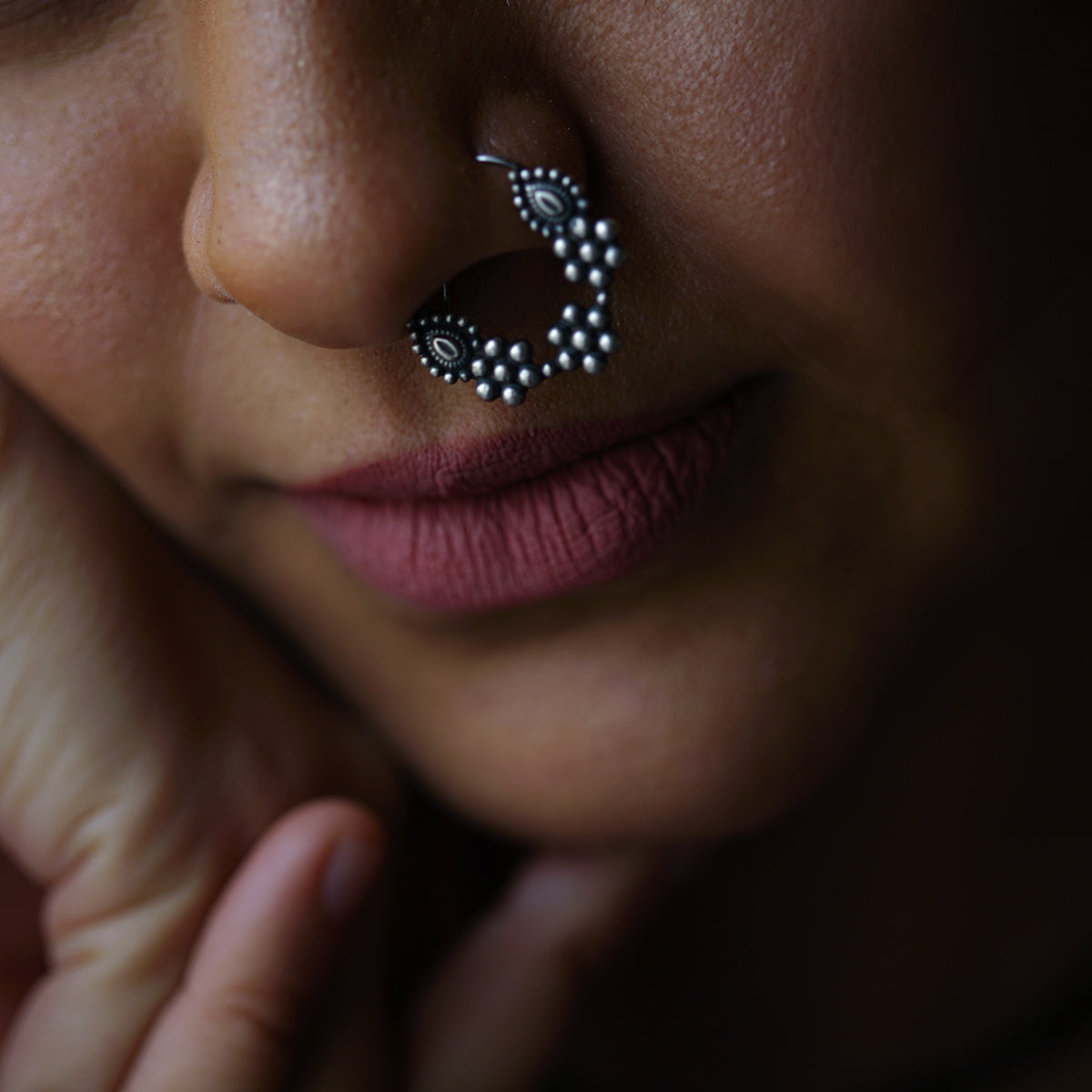 a close up of a person with a nose piercing