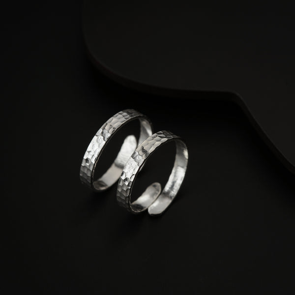 Model wearing silver hammered toe ring on beach with natural sunlight lifestyle setting