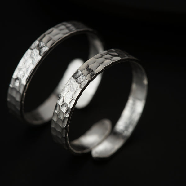 Macro detail of hammered texture on 92.5 sterling silver toe ring with high-polish finish