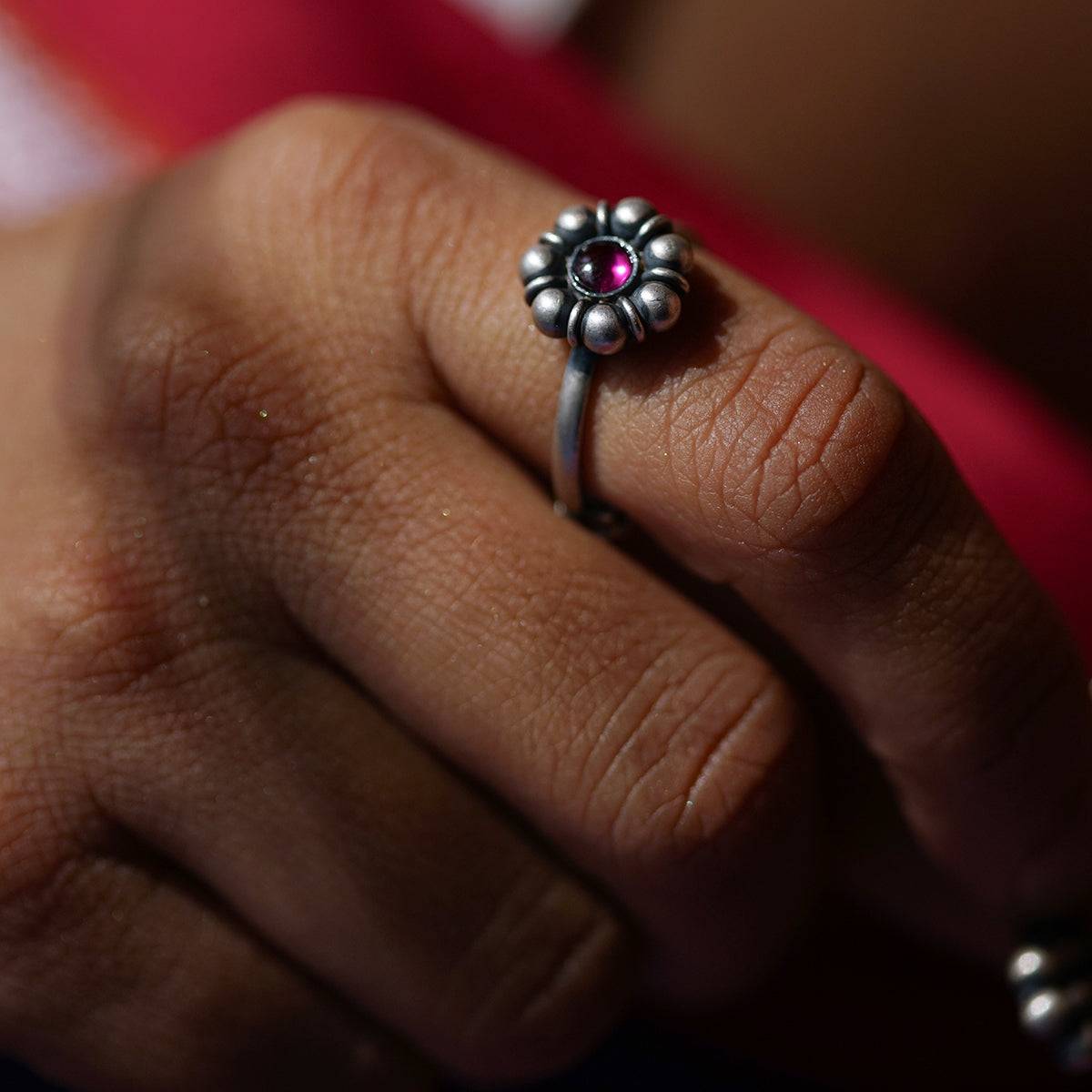 a close up of a person's hand with a ring on it