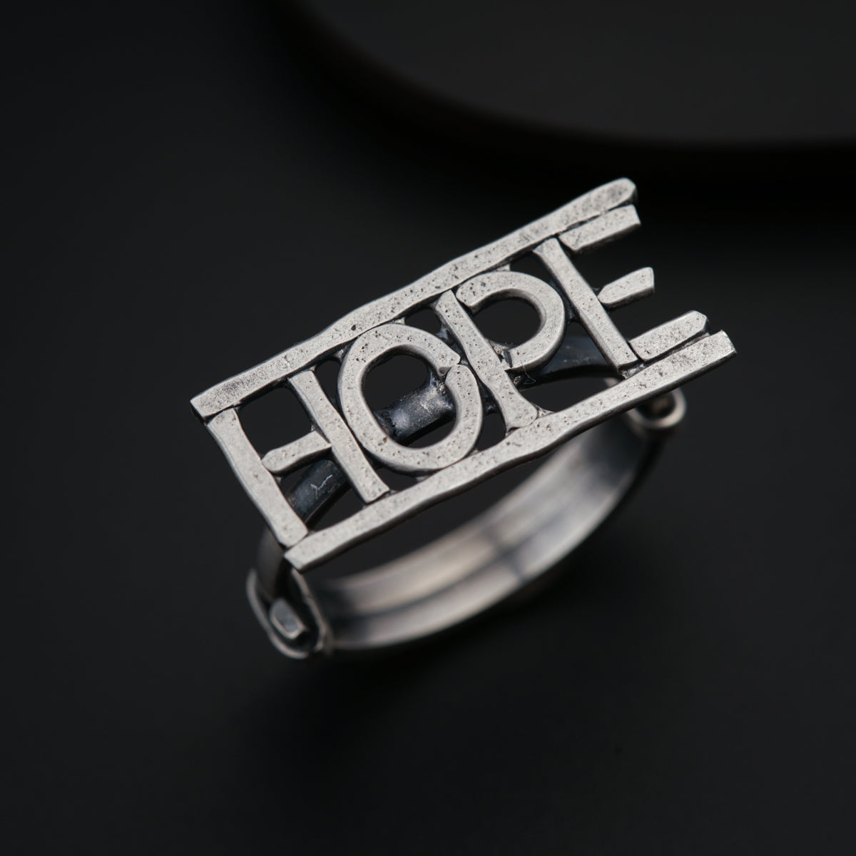 a silver ring with the word hope on it