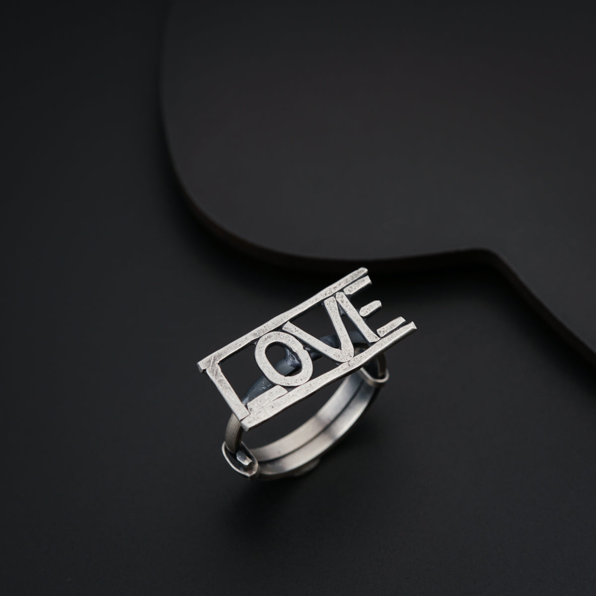 a silver ring with the word love on it