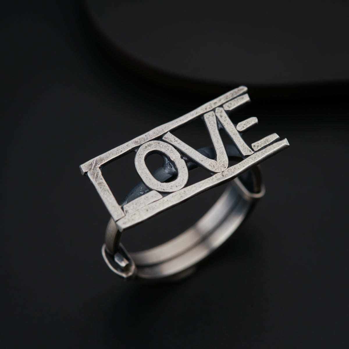 a silver ring with the word love on it