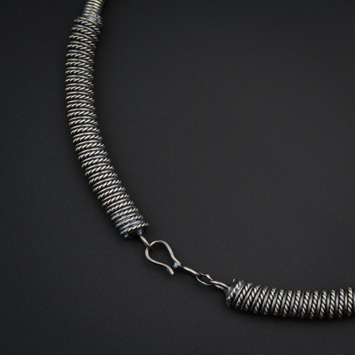a close up of a necklace on a black surface