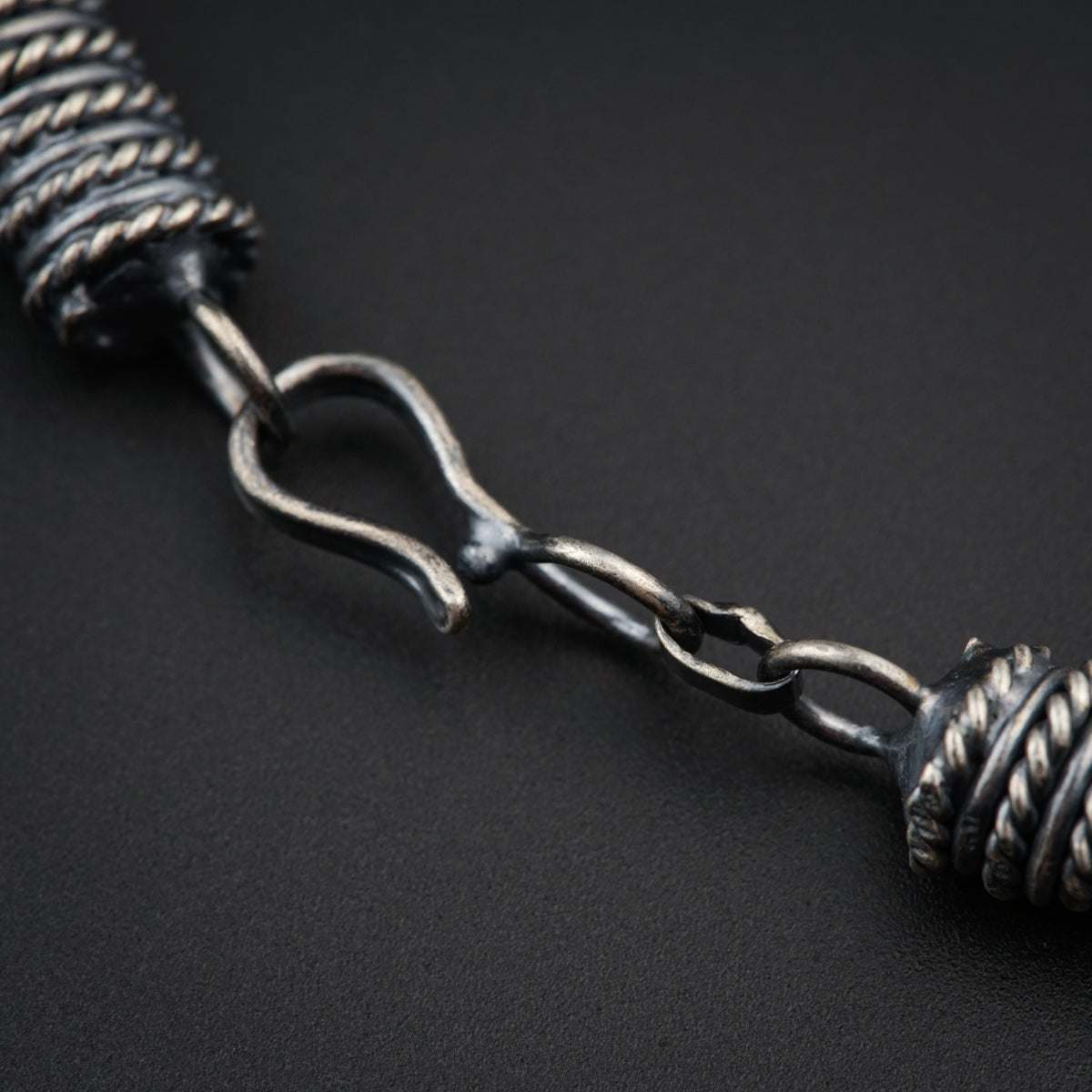 a close up of a metal object on a black surface