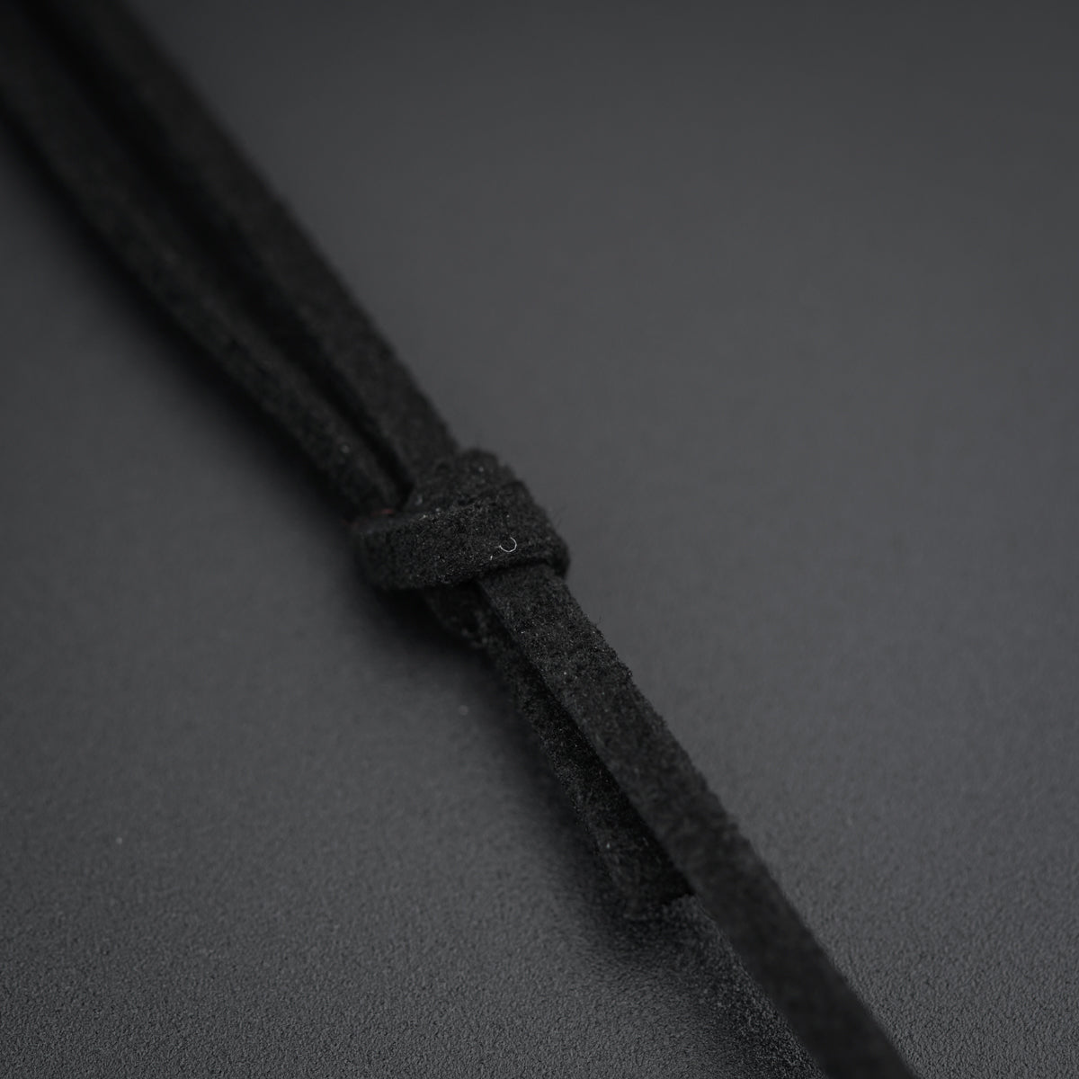 a close up of a black cord on a gray surface
