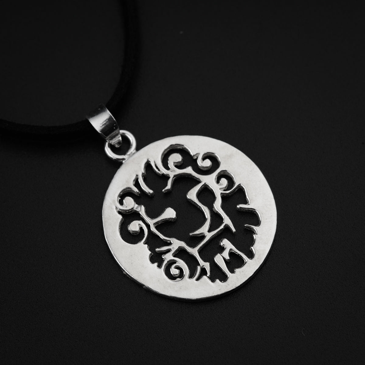 a silver pendant with a lion on it
