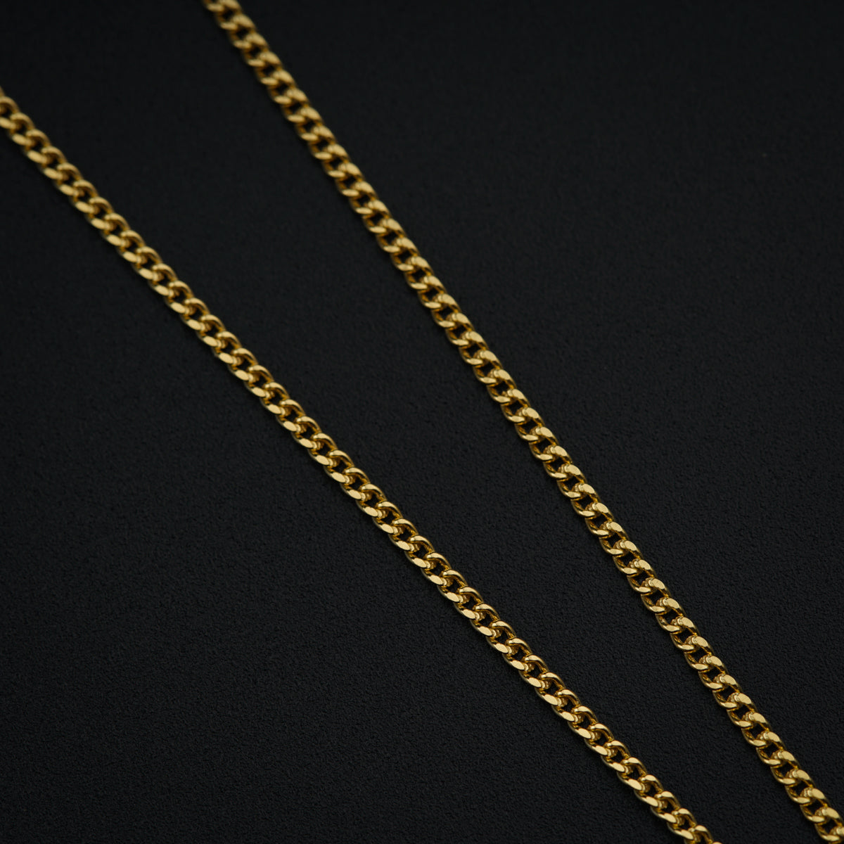 a gold chain on a black background