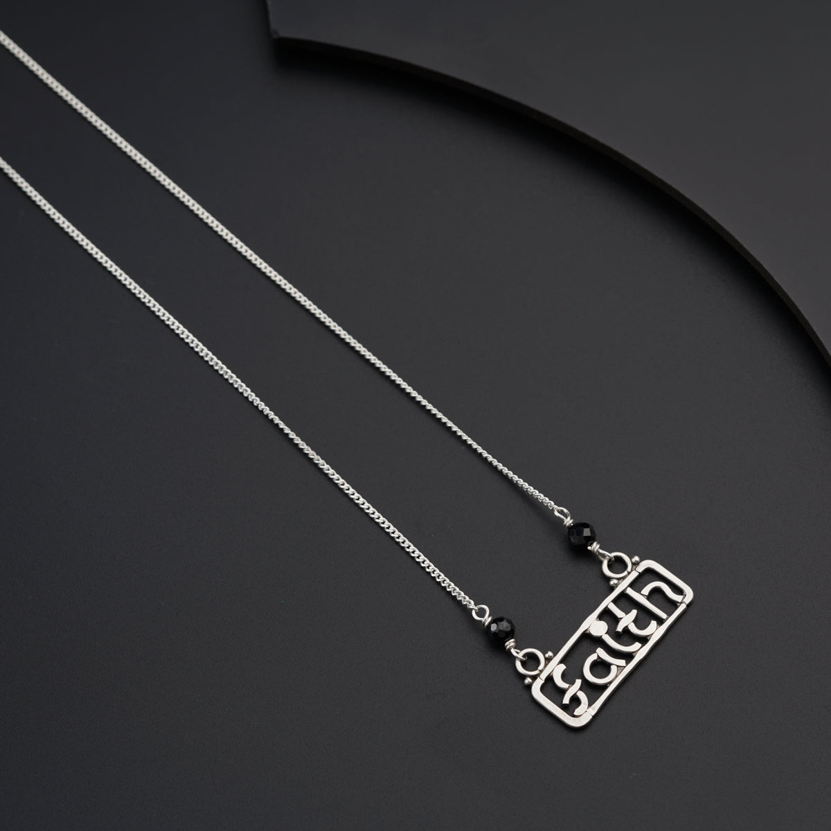 a couple of necklaces sitting on top of a table