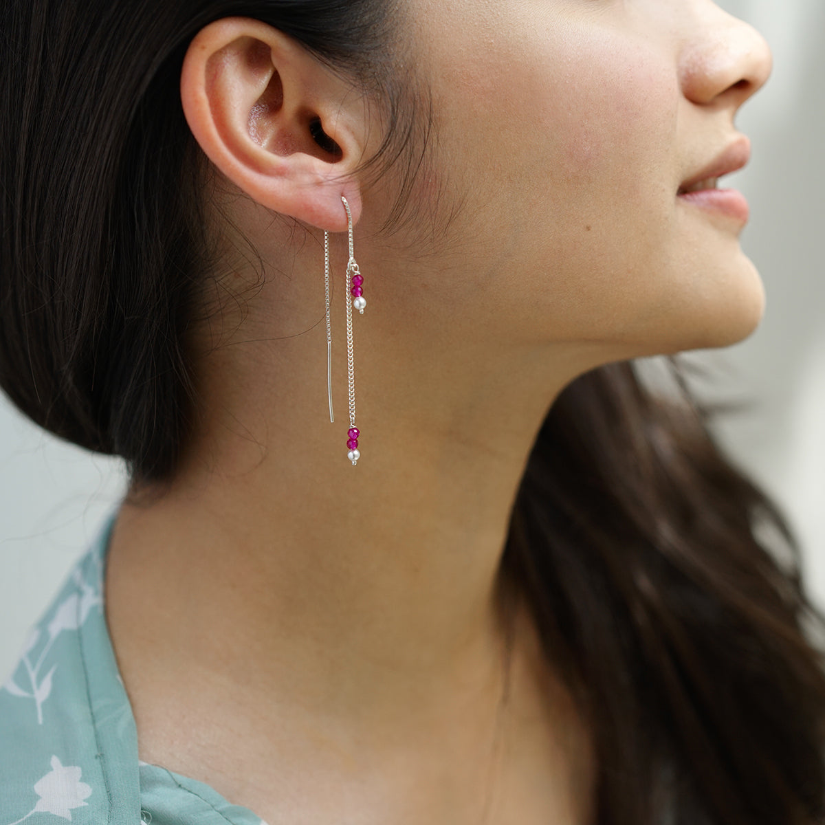 a close up of a person wearing a pair of earrings