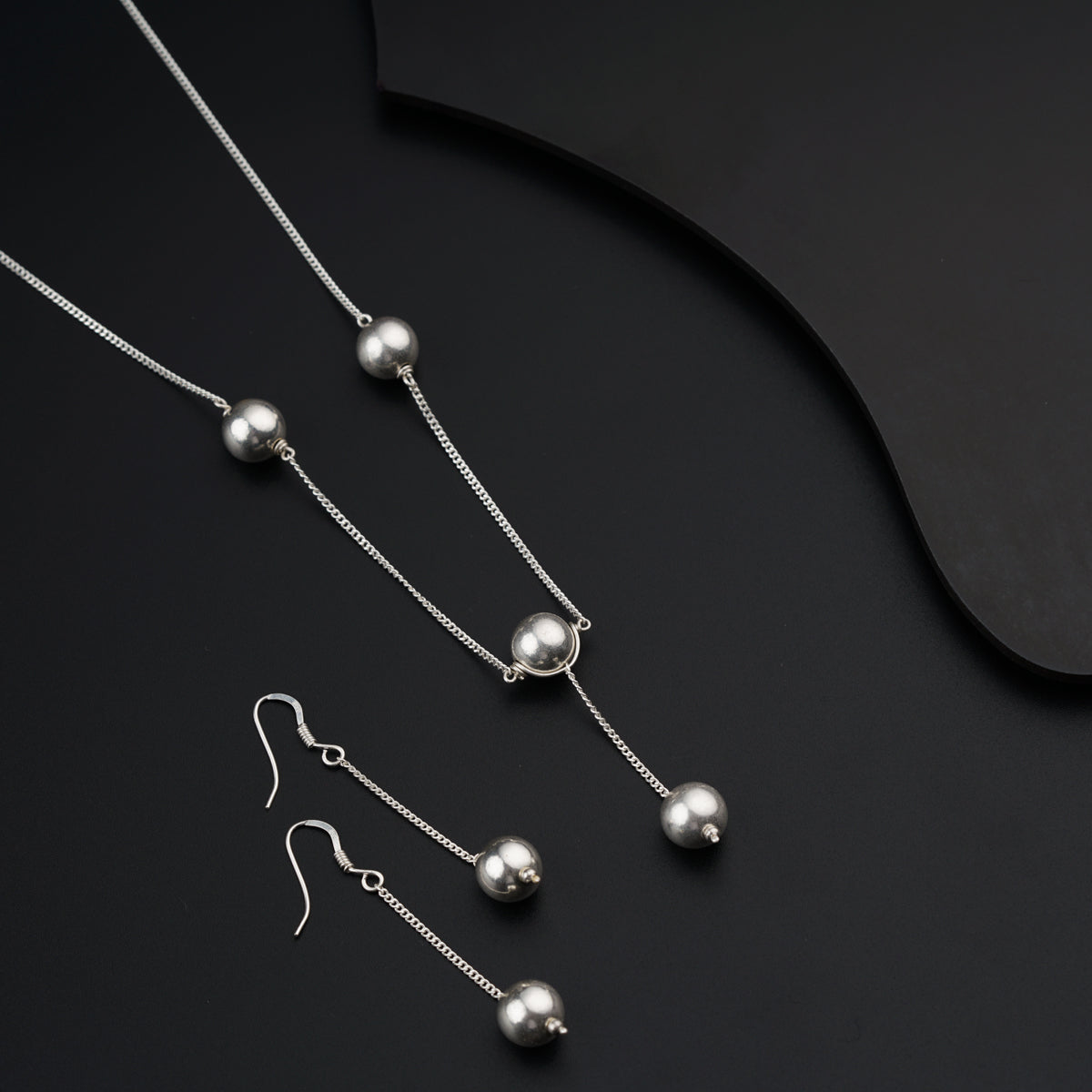 a set of three necklaces and a pair of earrings