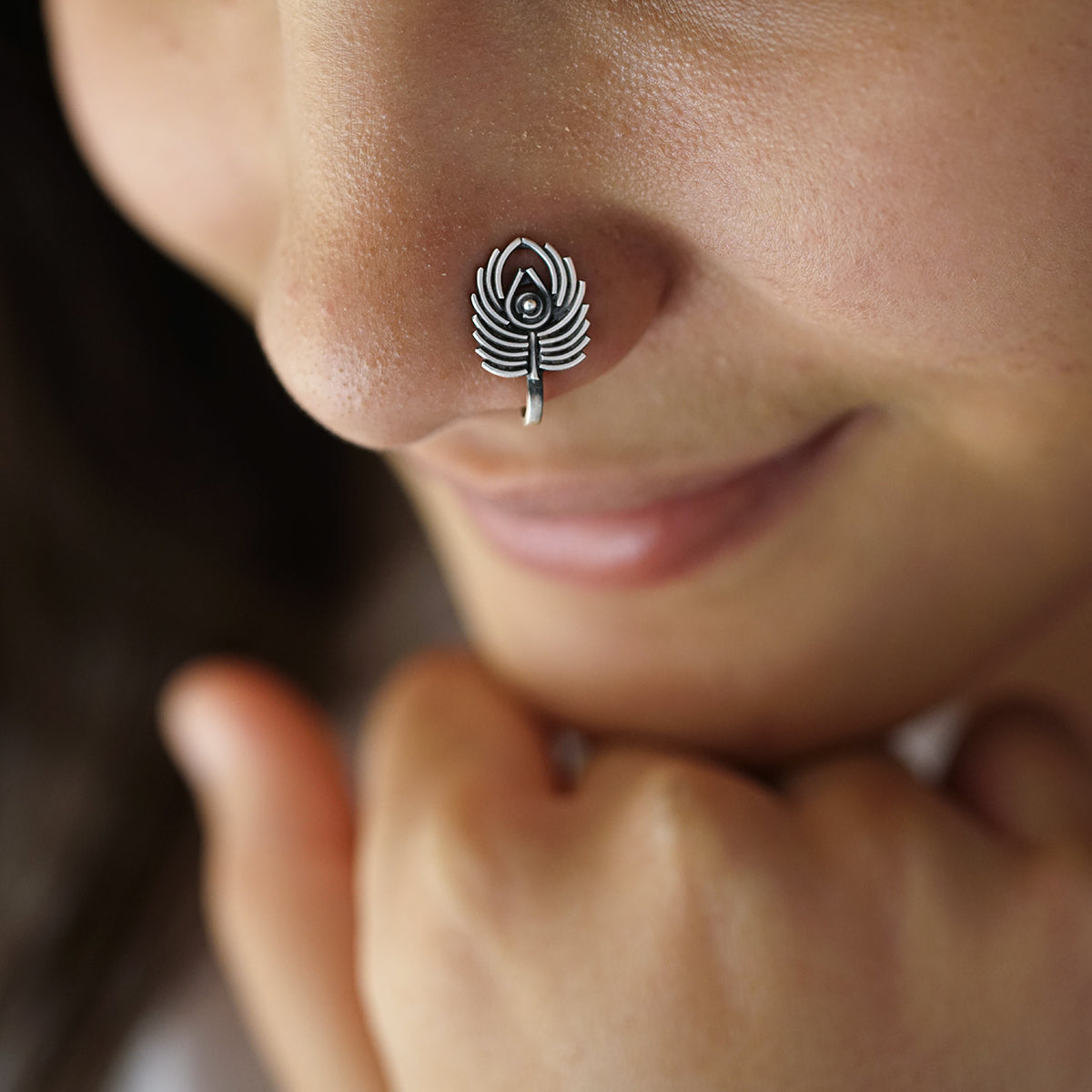 a close up of a person with a nose piercing