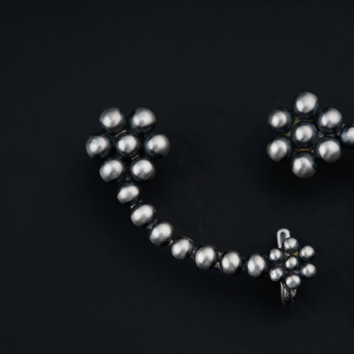 a close up of a metal object on a black surface