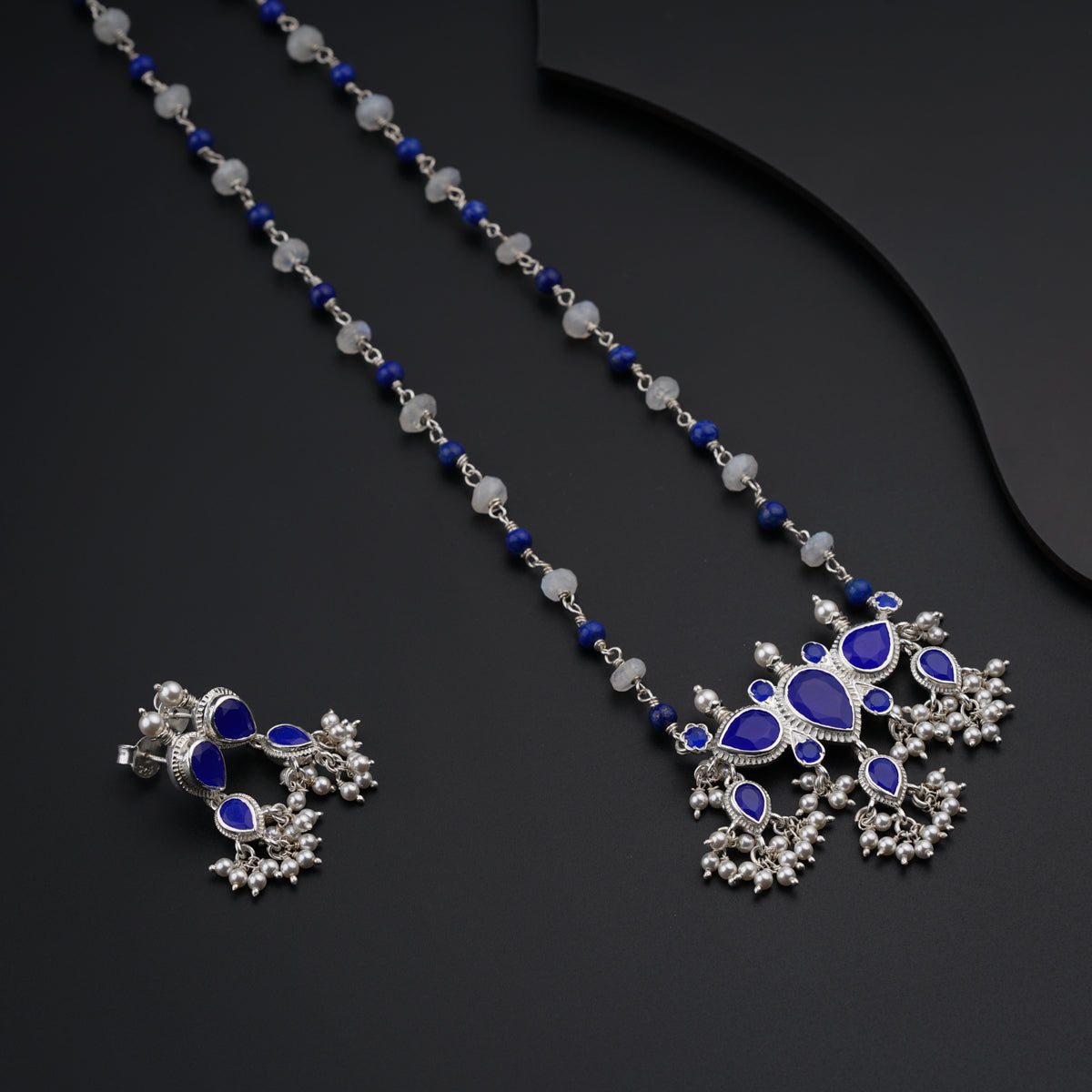 a necklace and earring set with blue stones