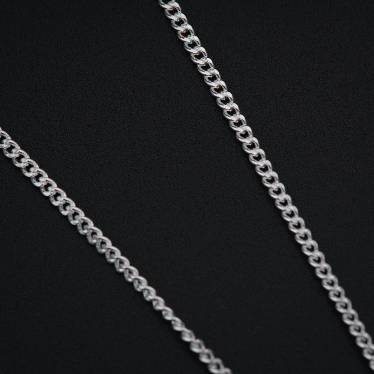 a close up of a chain on a black background