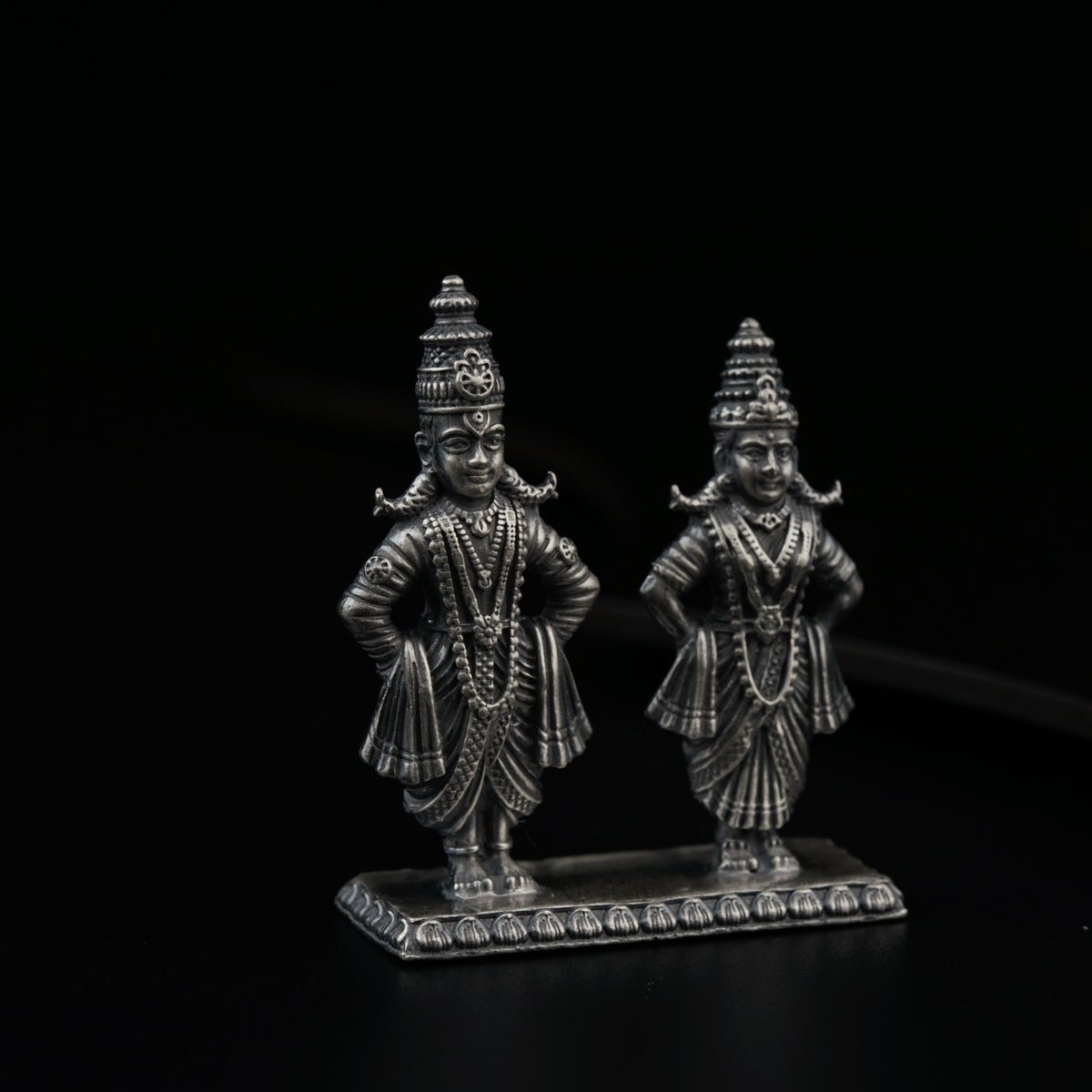 a couple of statues sitting on top of a table