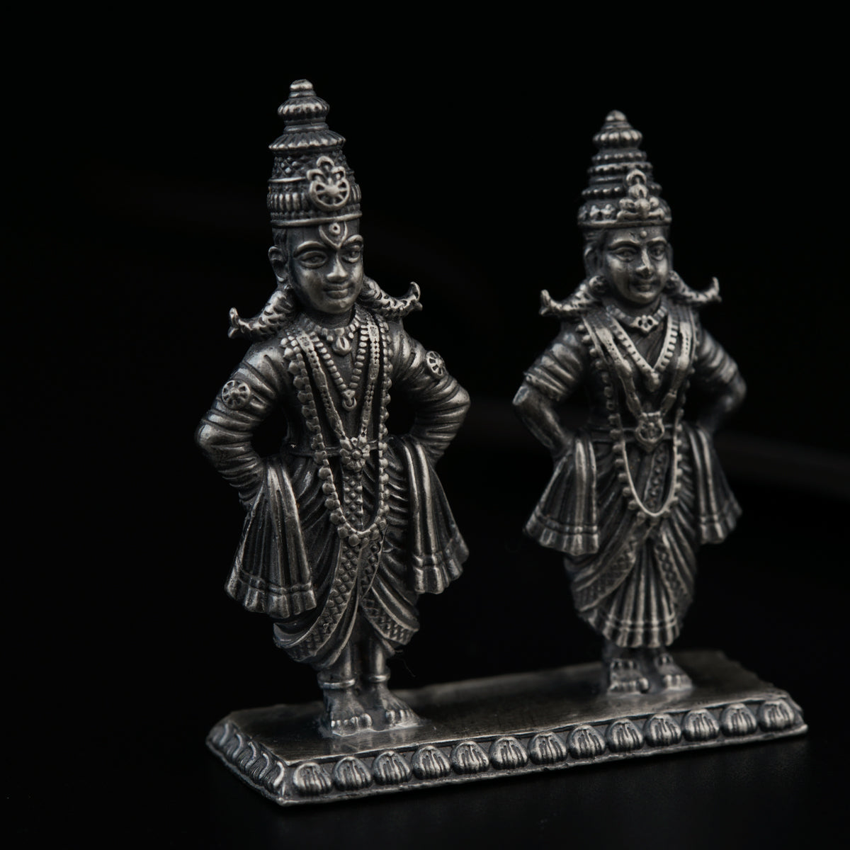 a couple of statues sitting on top of a table