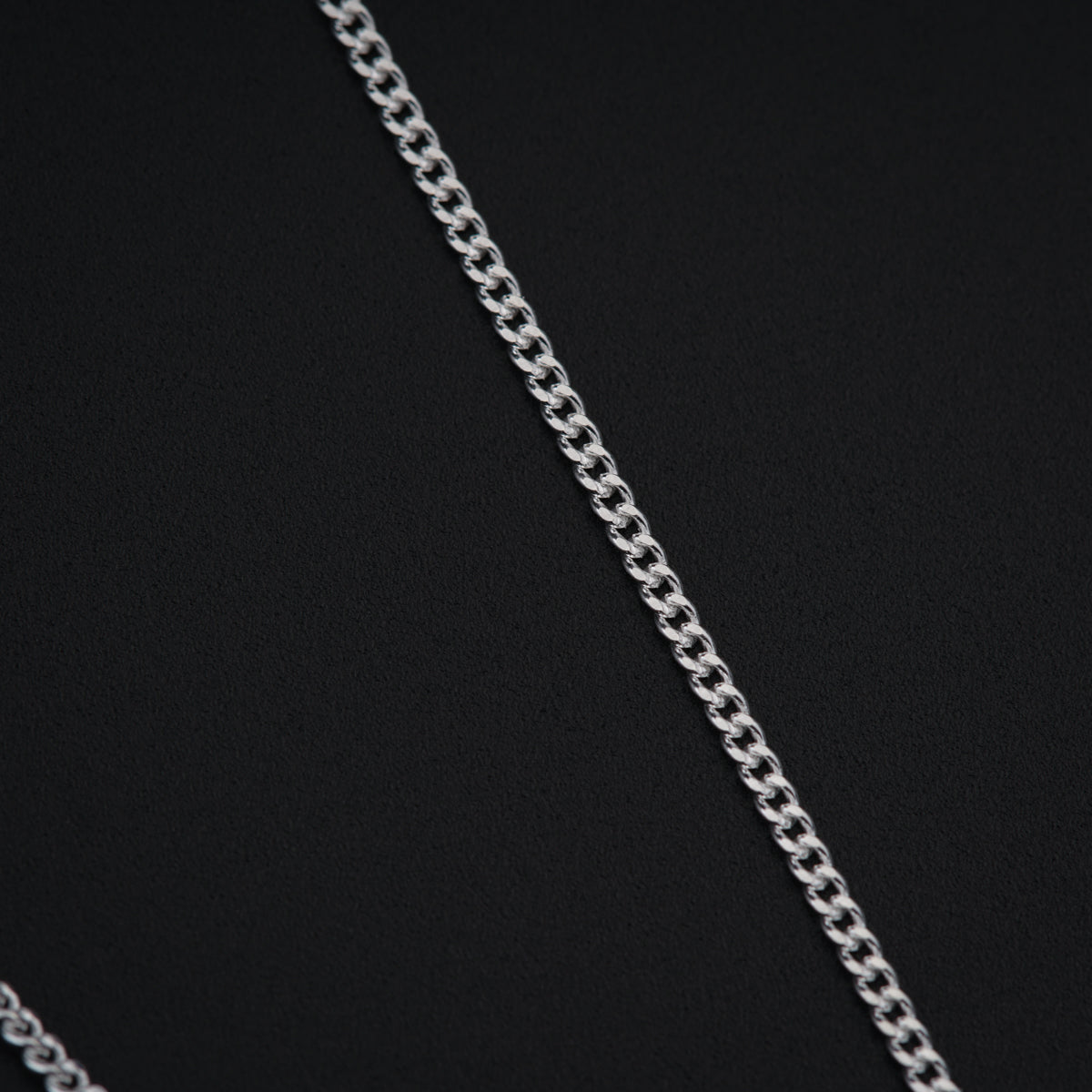 a close up of a chain on a black surface