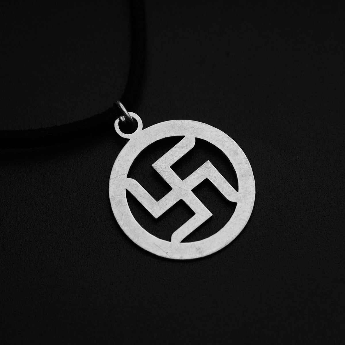 a silver pendant with a hammer on it