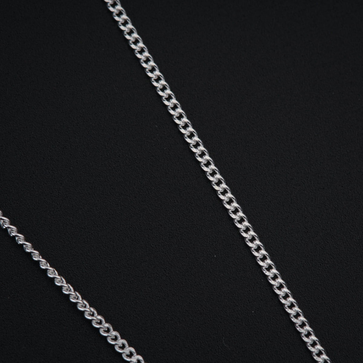 a close up of a chain on a black surface