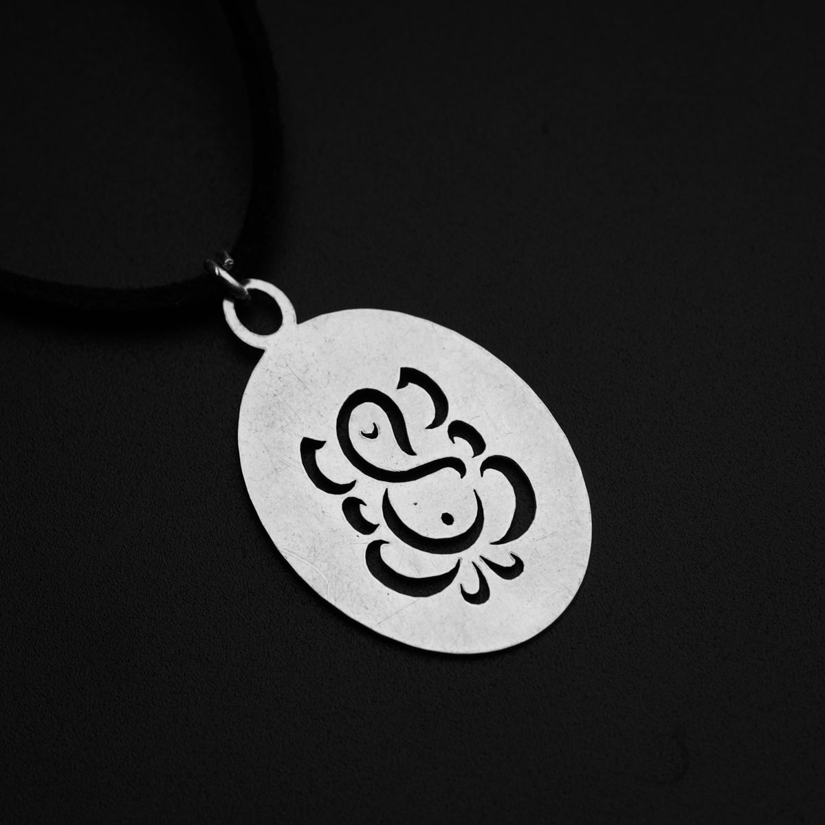 a silver pendant with an elephant on it