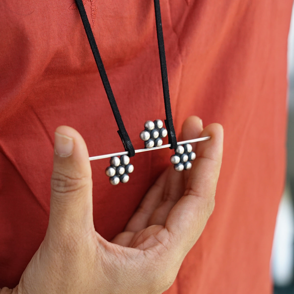 a man is holding a pair of black and white beads