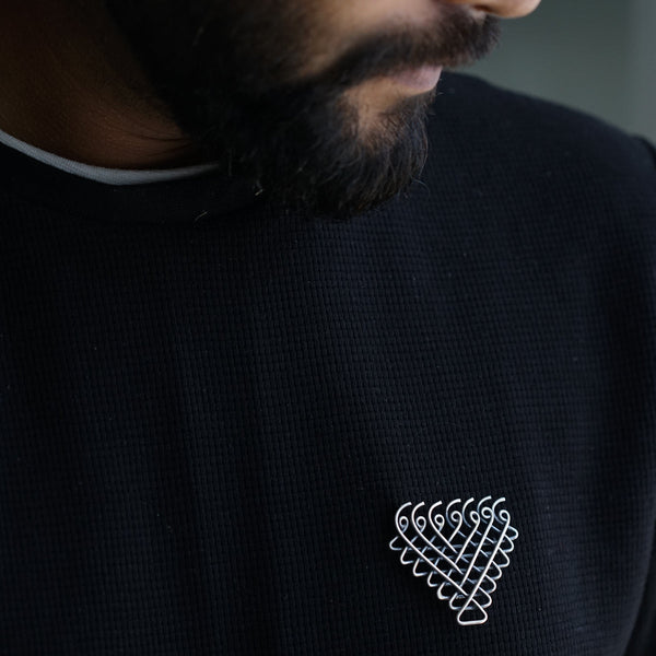 a man with a beard wearing a black shirt