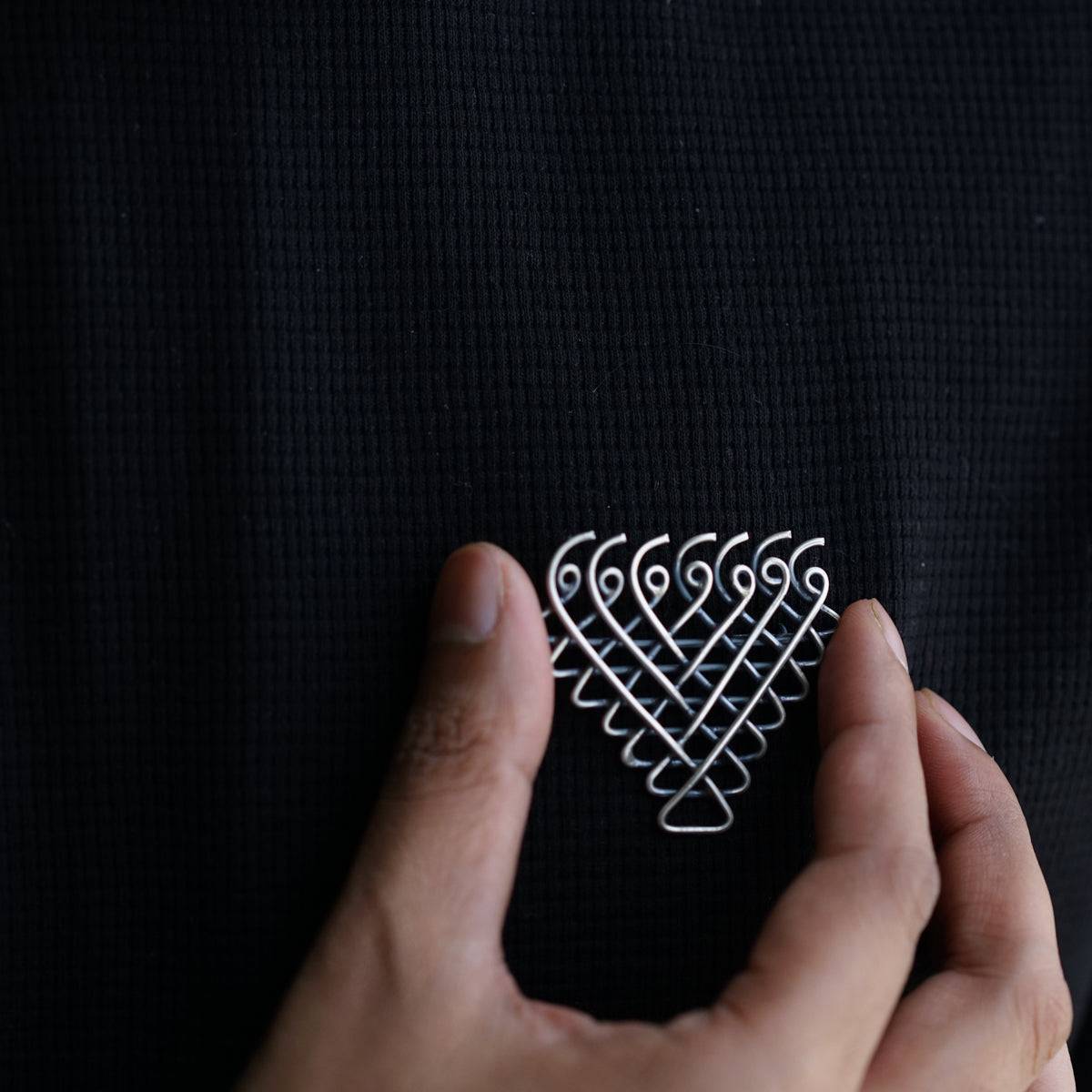 a person holding a piece of metal wire