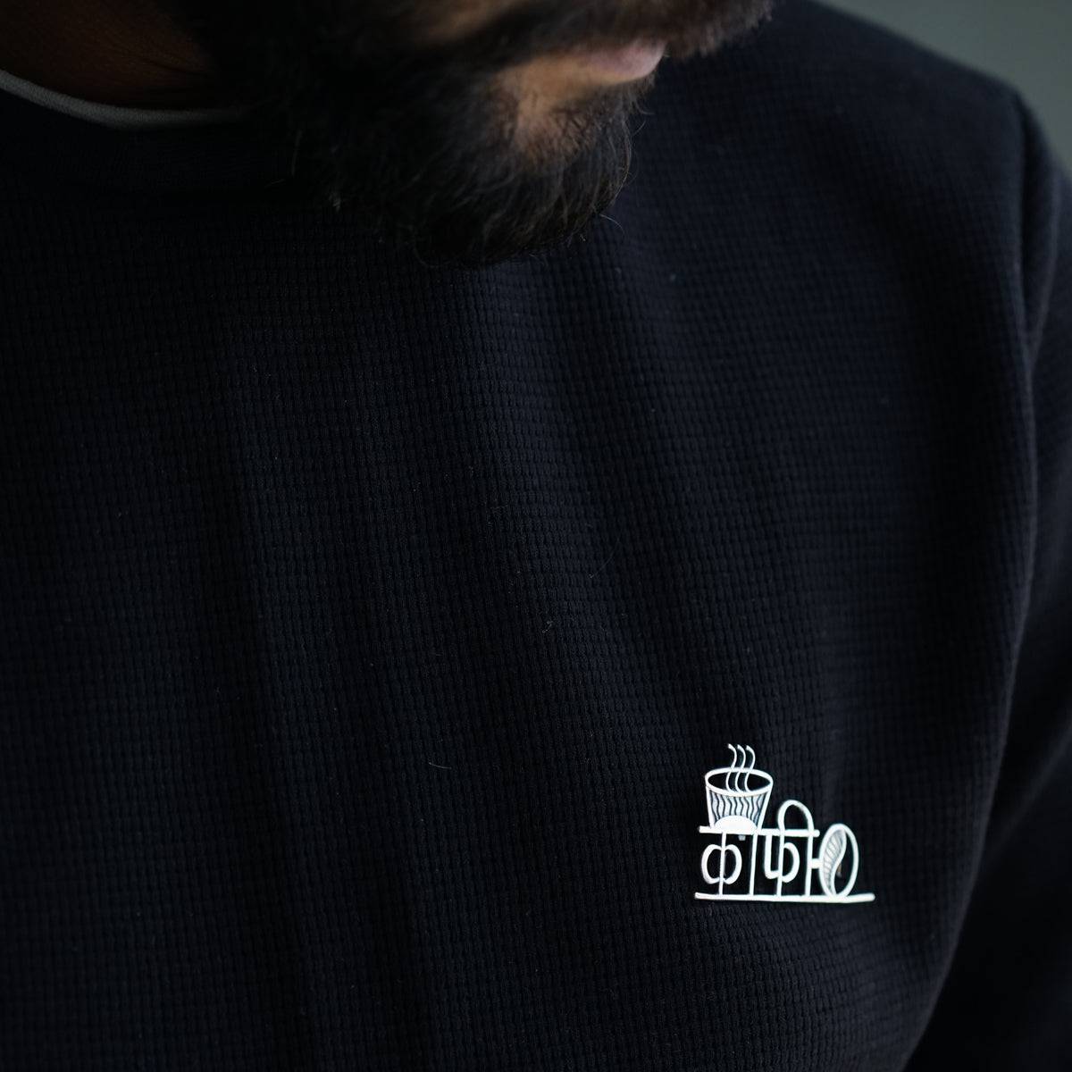 a man with a beard wearing a black shirt