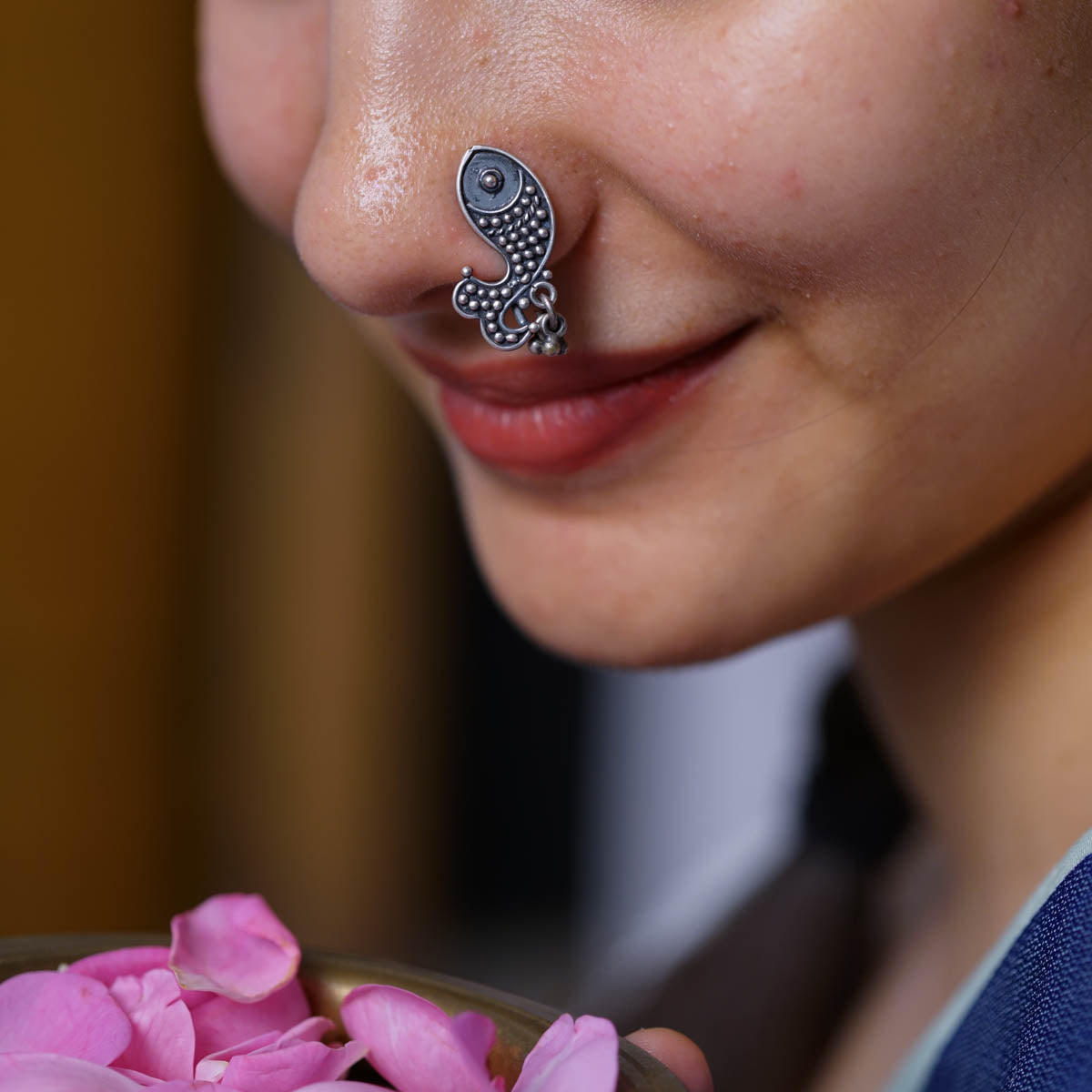a close up of a person with a nose piercing