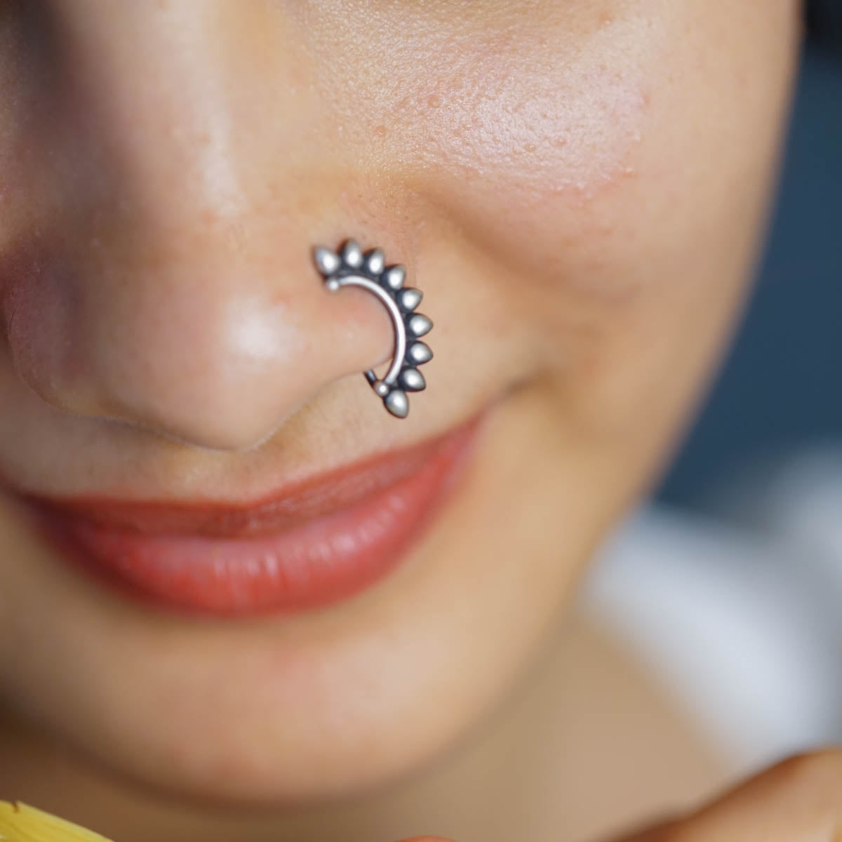 a close up of a person with a nose piercing