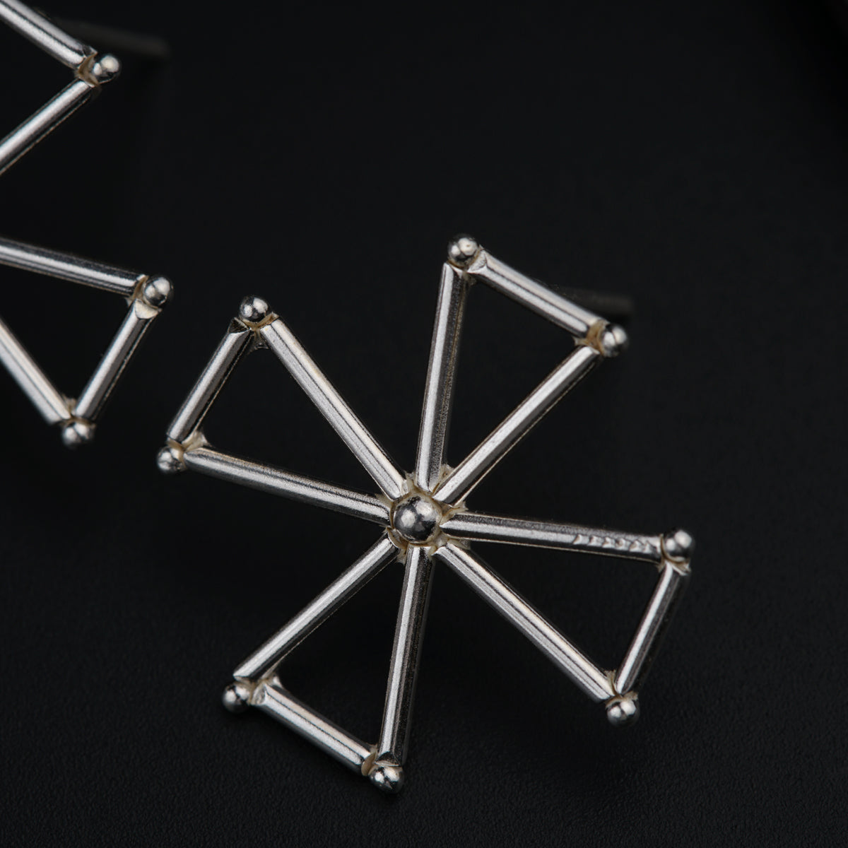 a close up of a metal object on a black surface