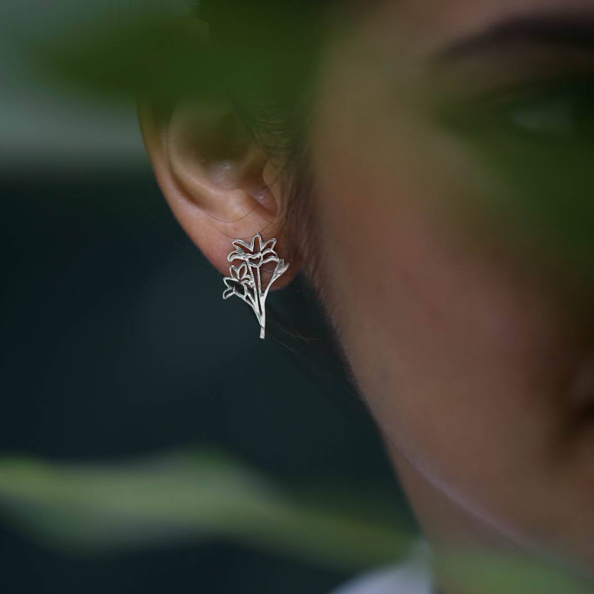 a close up of a person wearing a pair of earrings