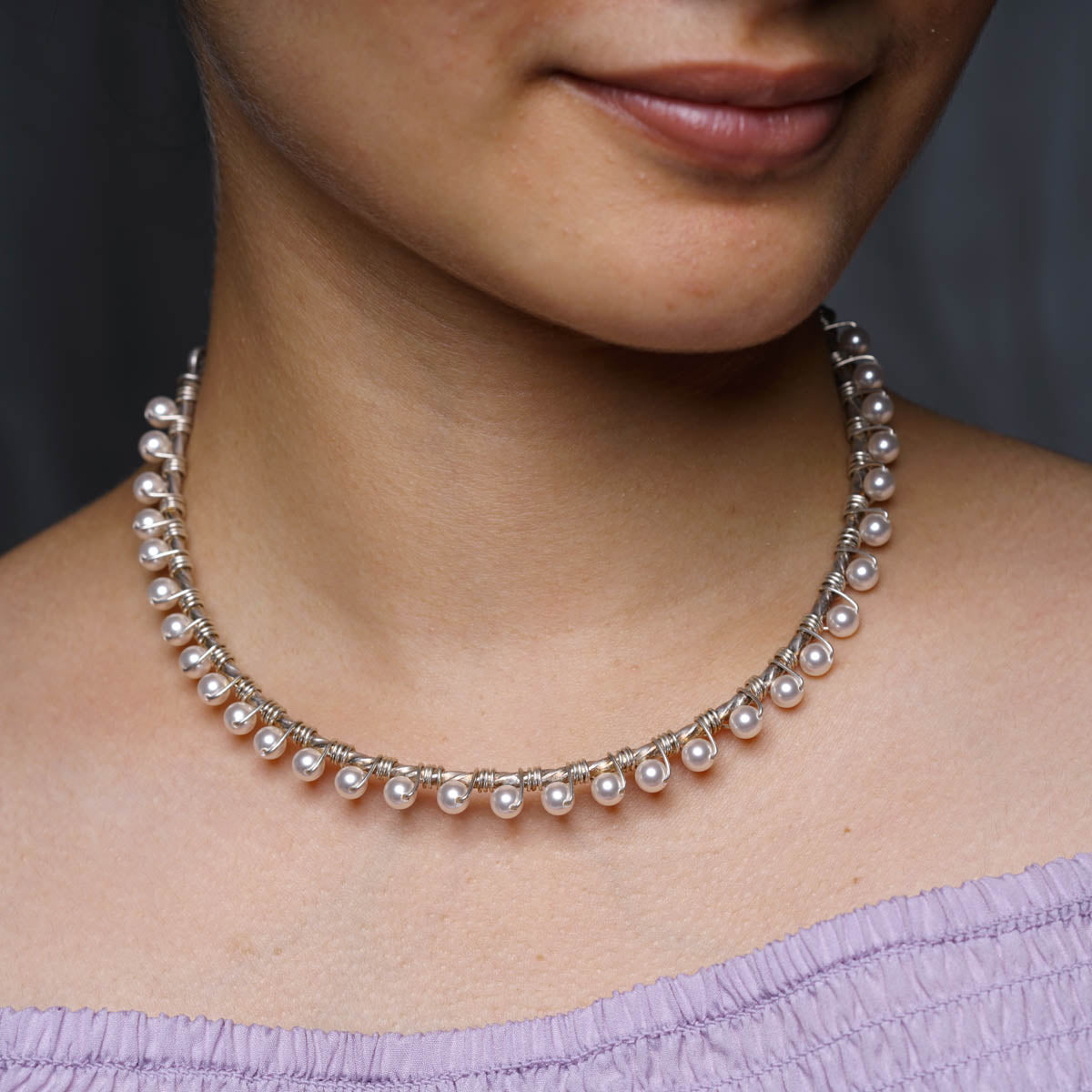 a close up of a woman wearing a necklace