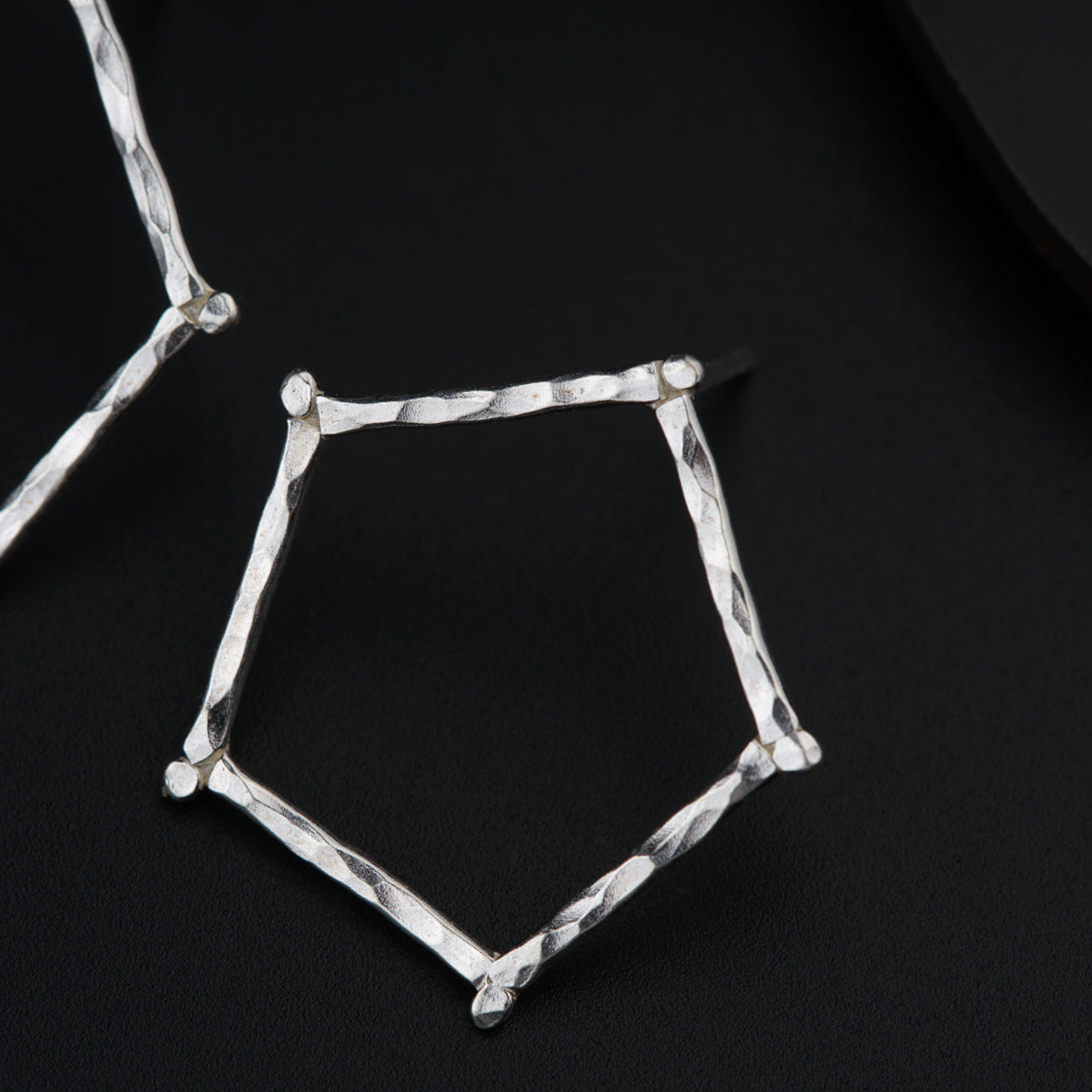 a close up of two pieces of metal on a black surface