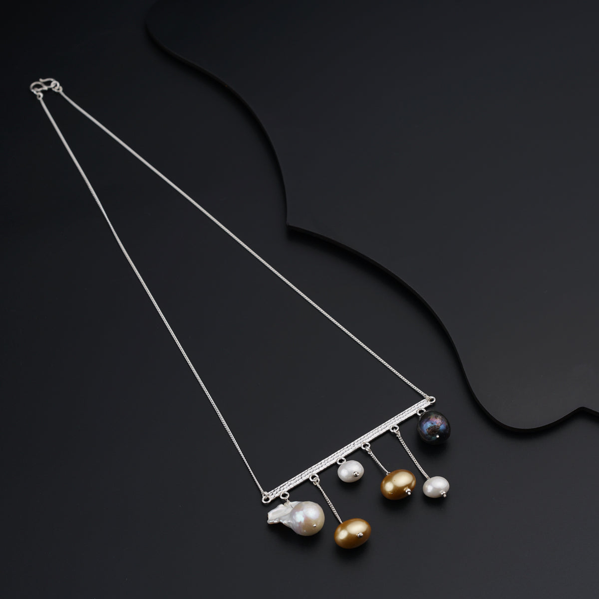 a necklace with pearls hanging from it