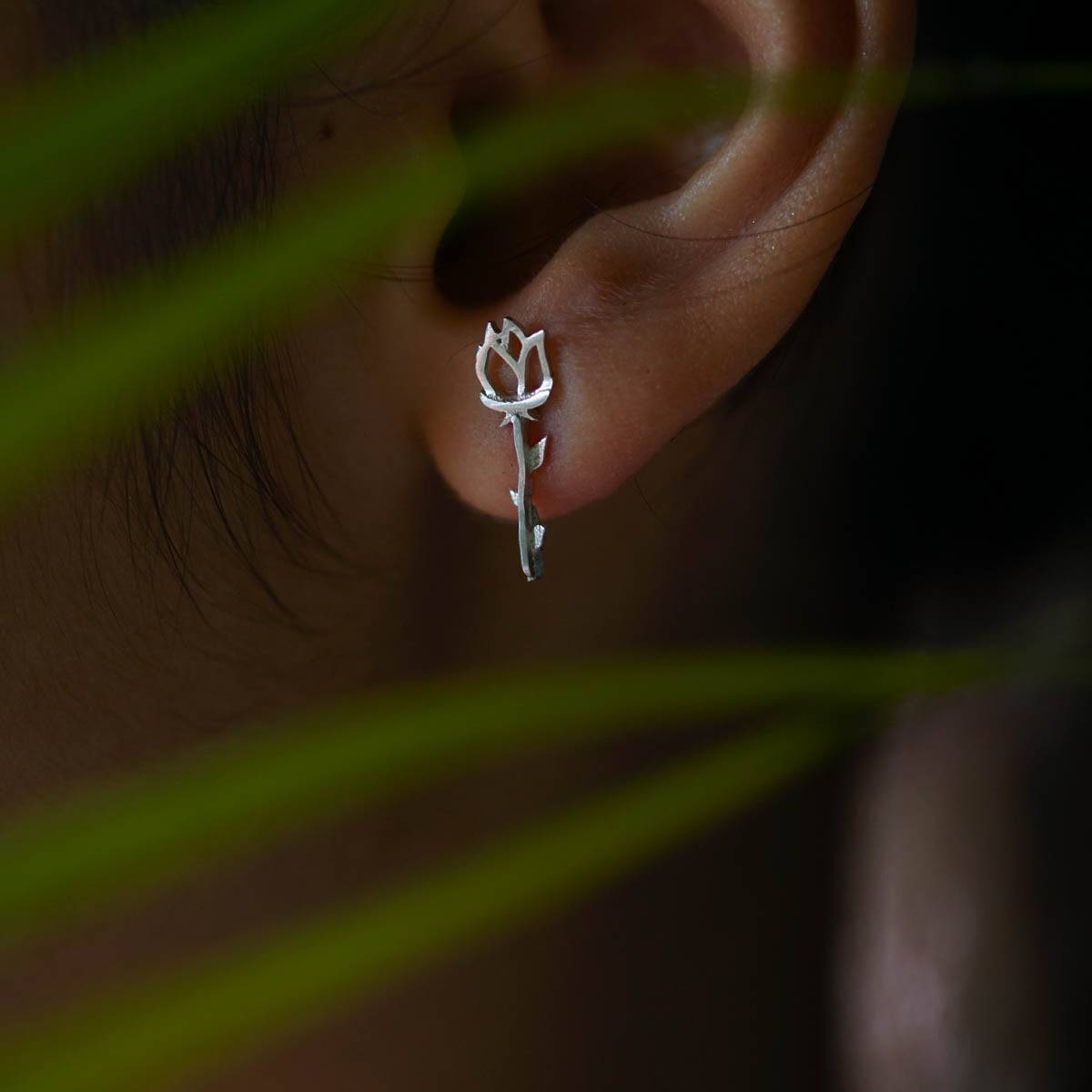 a close up of a person's ear with a pair of scissors in it