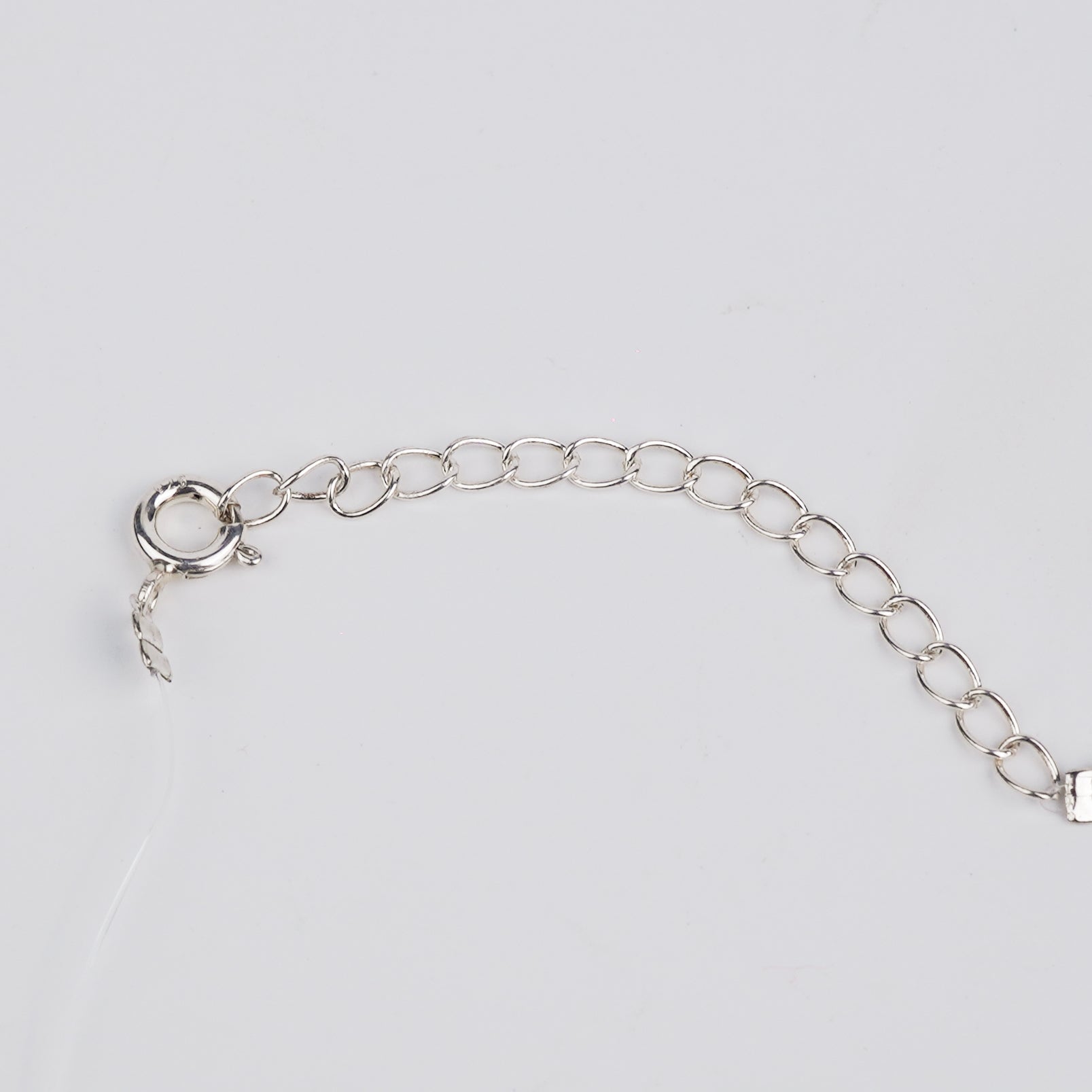 Meena charm set with invisible thread