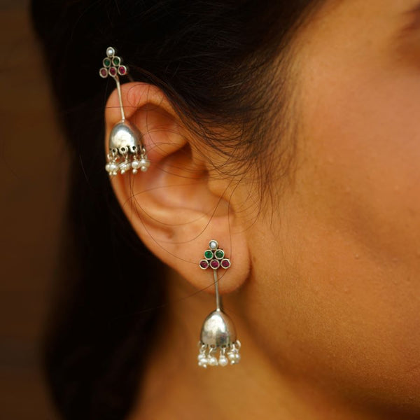 a close up of a person wearing a pair of earrings