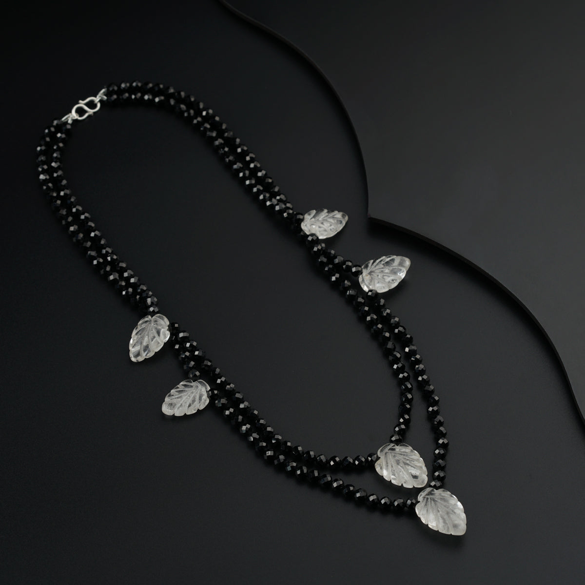 a black beaded necklace with clear stones